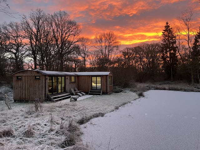 Lodge at sunrise with frozen pond